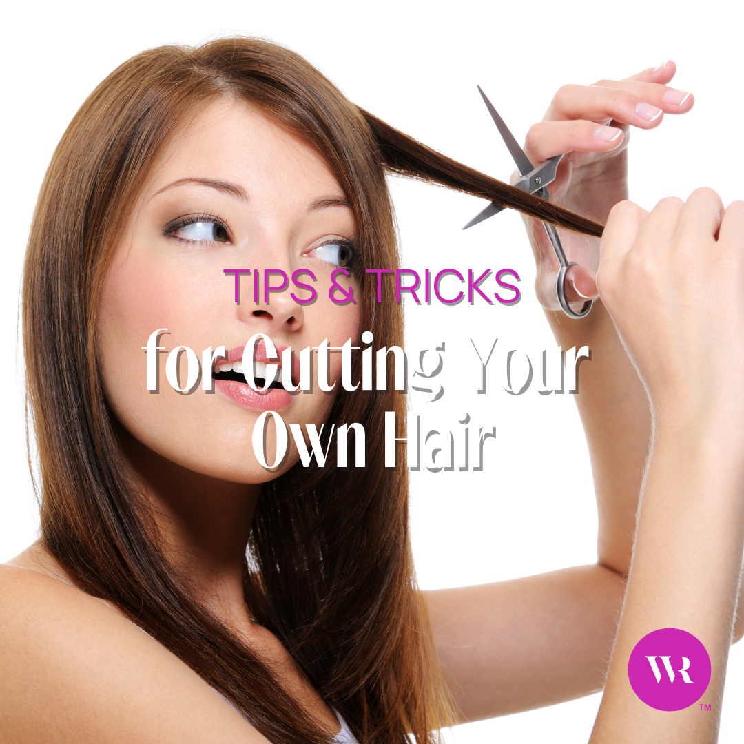A woman with brown hair attempting to cut her own hair with scissors